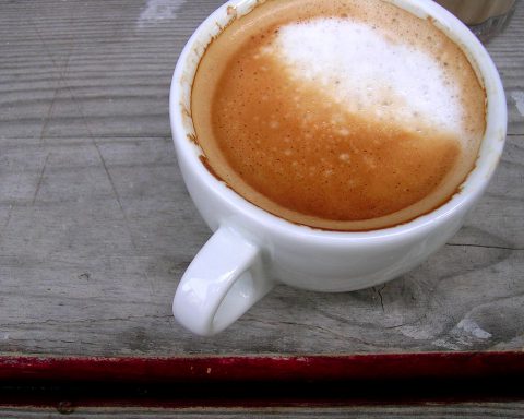 coffee in a porcelain mug on a wooden table