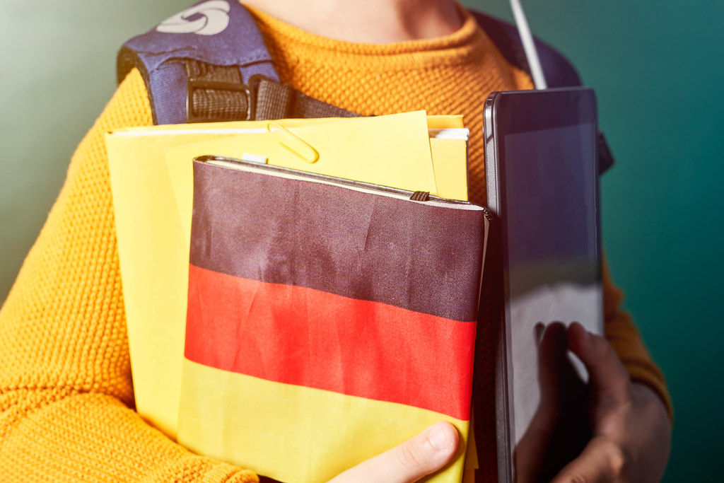 Student holding book wrapped in German flag paper