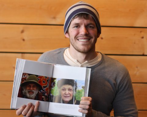 Portrait of Brandon Stanton with Humans of New York book