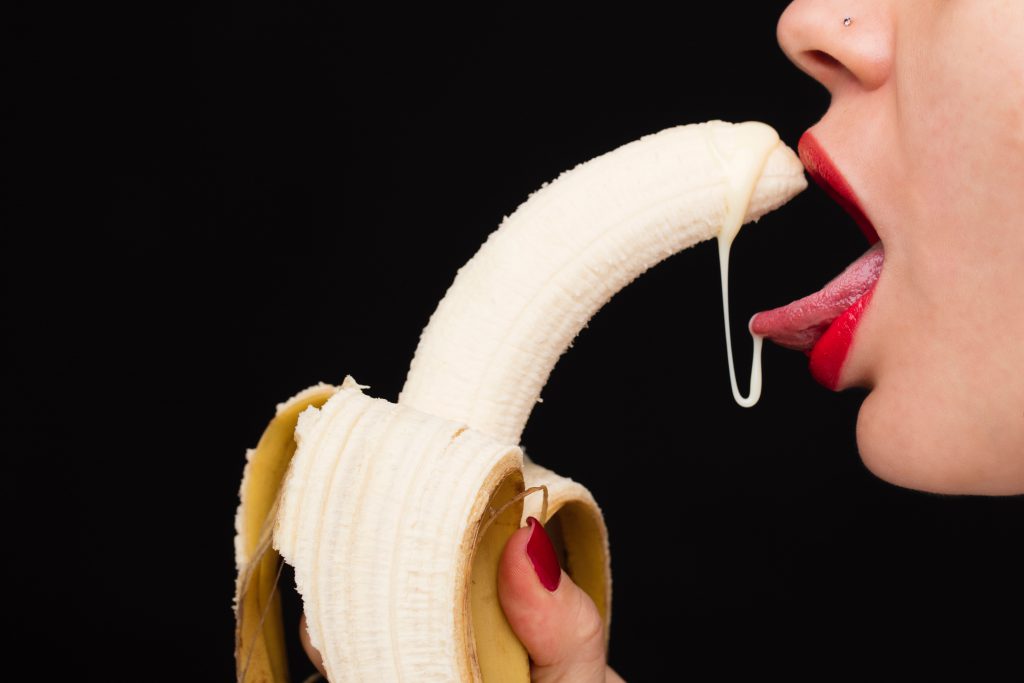 banana licked by woman