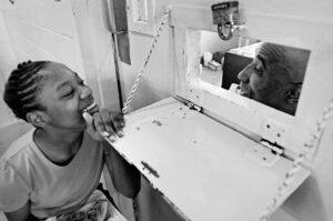 Girl visiting father in prison hospital ward