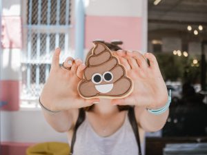 Woman holding poop emoji case