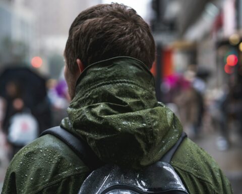 close-up photography of man wearing green hoodie