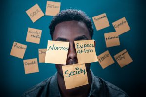 Black person covered in sticky notes
